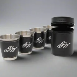 DESIGN MASTER ASSOCIATES Set of Four Stainless Steel and Leather Shot Glasses